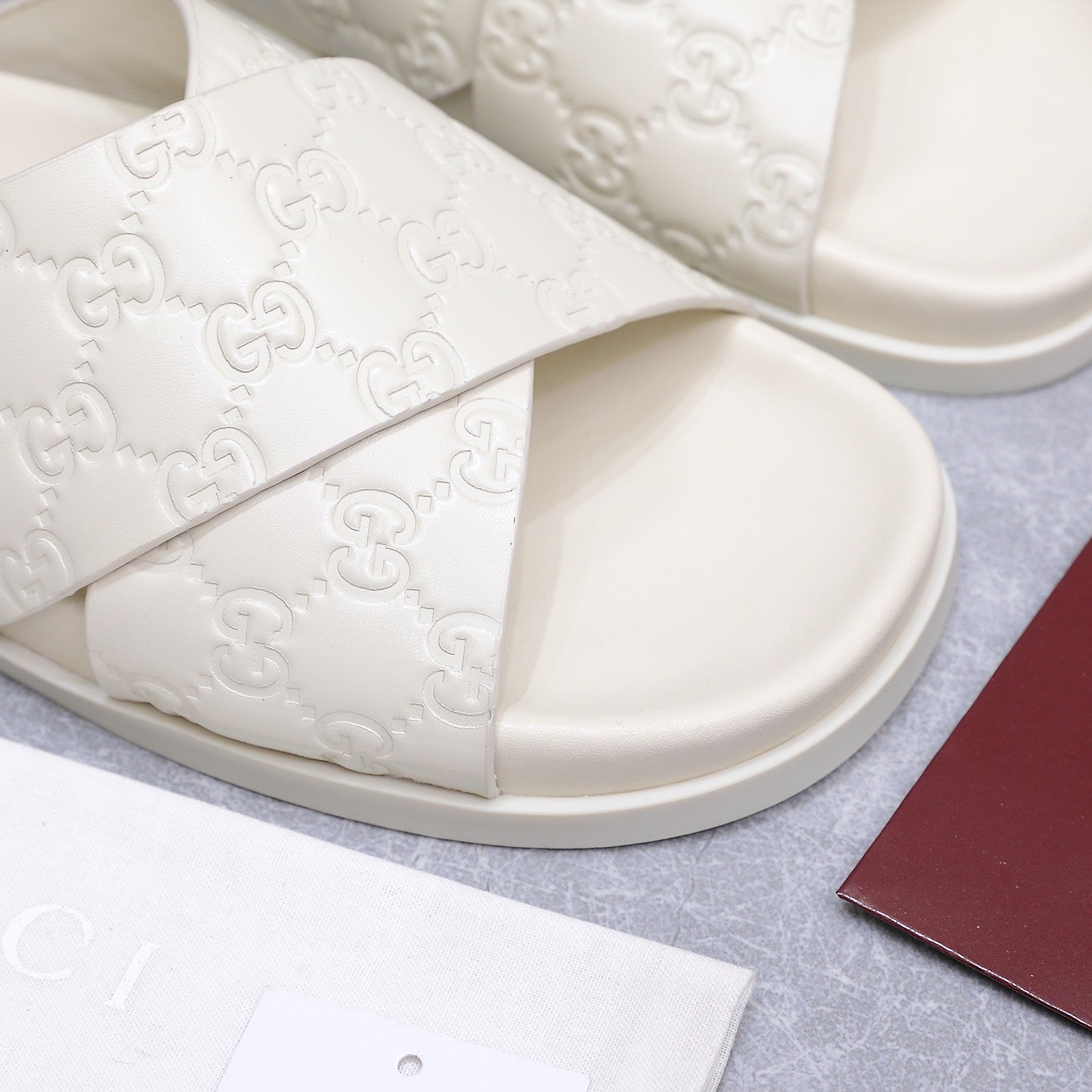 GUCCI 26S CROSSOVER SANDALS IN WHITE GG EMBOSSED CALFSKIN