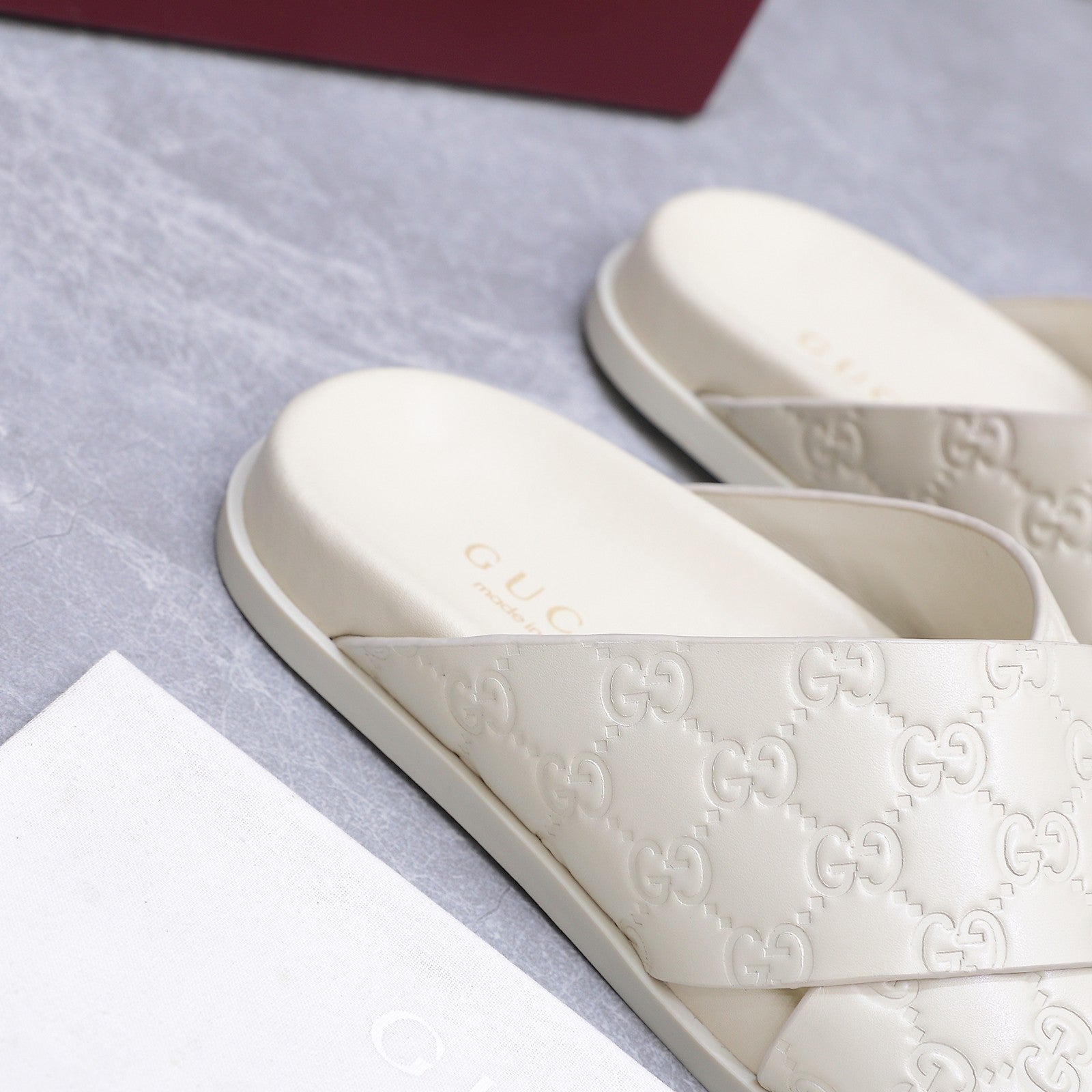 GUCCI 26S CROSSOVER SANDALS IN WHITE GG EMBOSSED CALFSKIN
