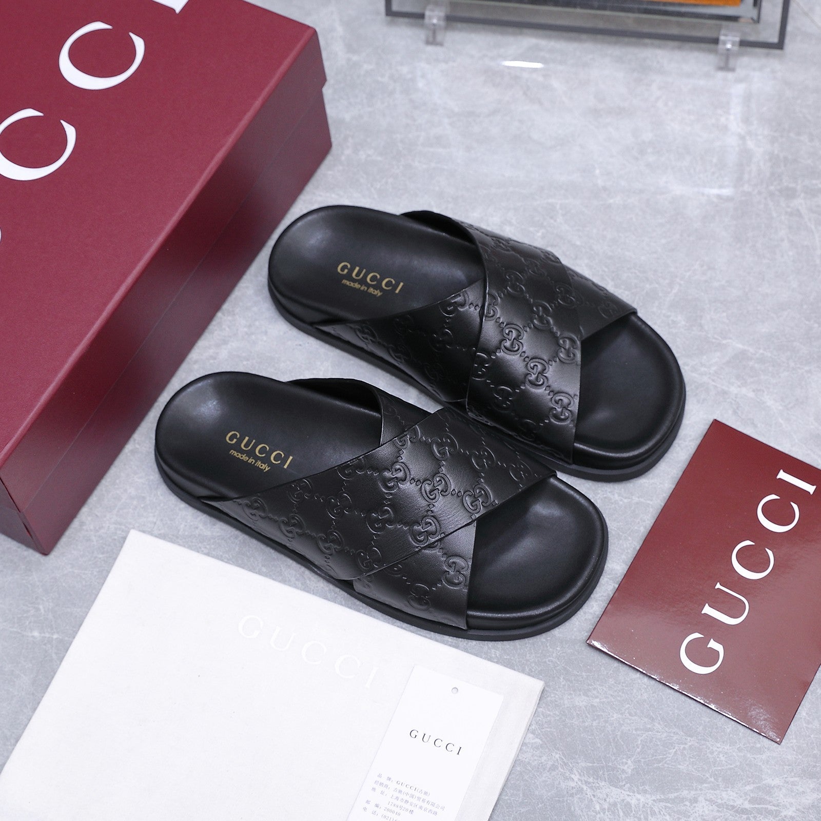 GUCCI 26S CROSSOVER SANDALS IN BLACK GG EMBOSSED CALFSKIN