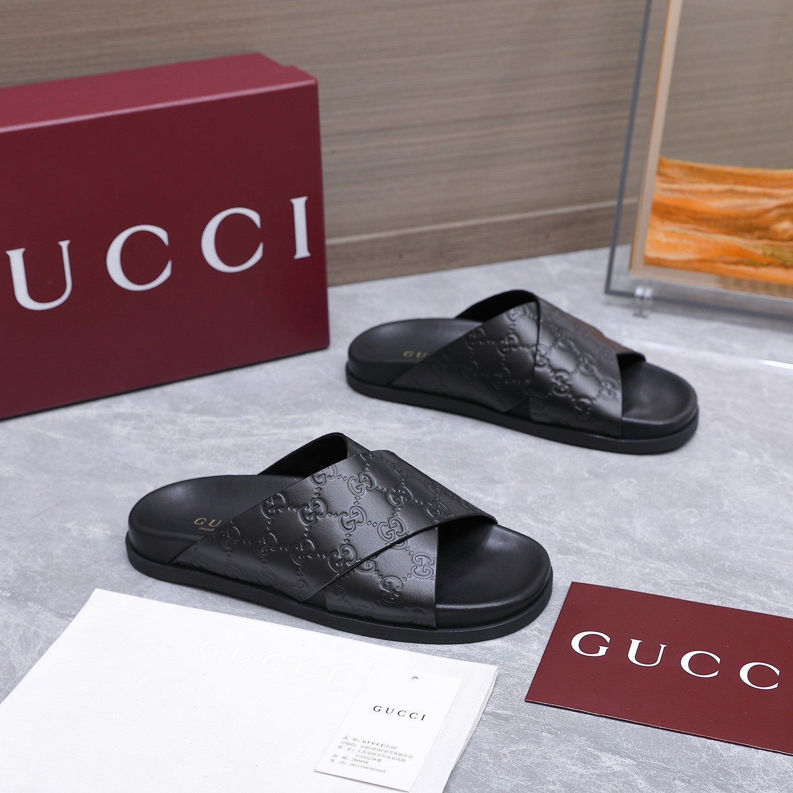 GUCCI 26S CROSSOVER SANDALS IN BLACK GG EMBOSSED CALFSKIN