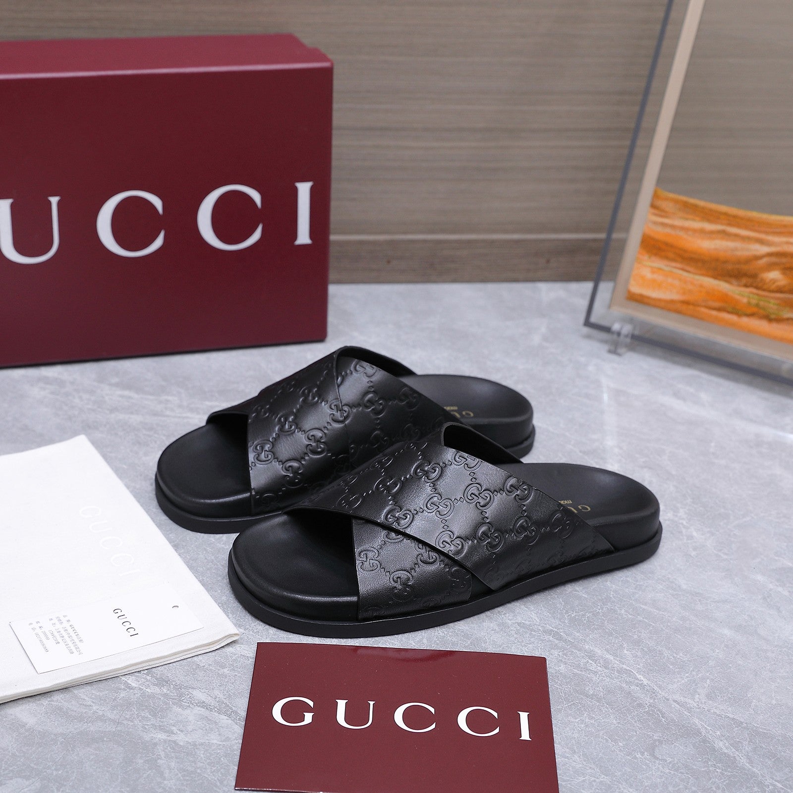 GUCCI 26S CROSSOVER SANDALS IN BLACK GG EMBOSSED CALFSKIN