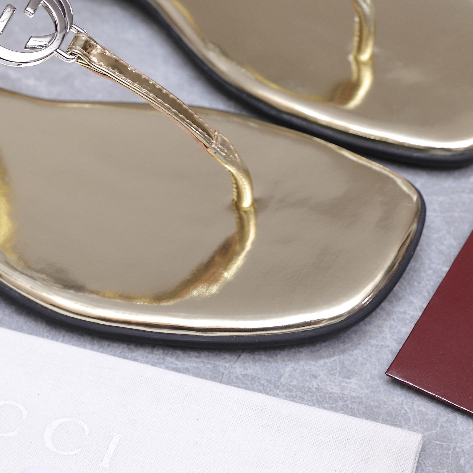 GUCCI 26S INTERLOCKING G THONG SANDALS IN GOLD CALFSKIN