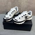 CHANEL 26S RUNNER CC LOGO SNEAKERS IN WHITE AND BLACK CALFSKIN
