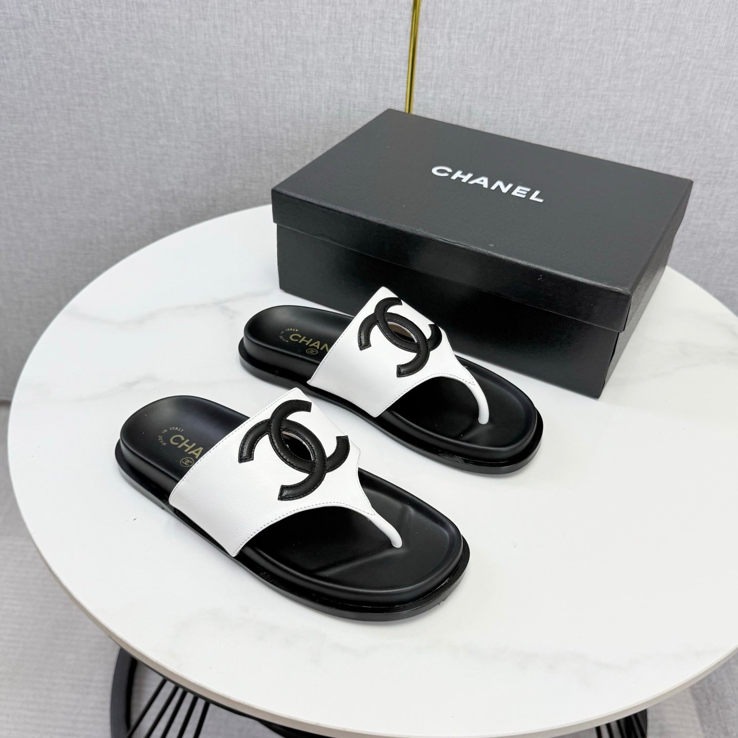 CHANEL 26S CC THONG SLIDES IN WHITE AND BLACK LAMBSKIN