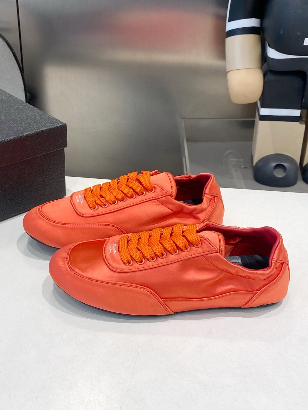 PRADA 26S SNEAKERS IN BURNT ORANGE SATIN