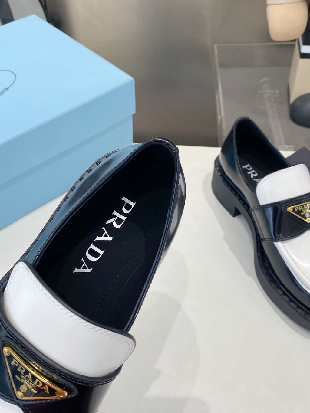 PRADA 26S LOAFERS IN BLACK AND WHITE CALFSKIN WITH LOGO
