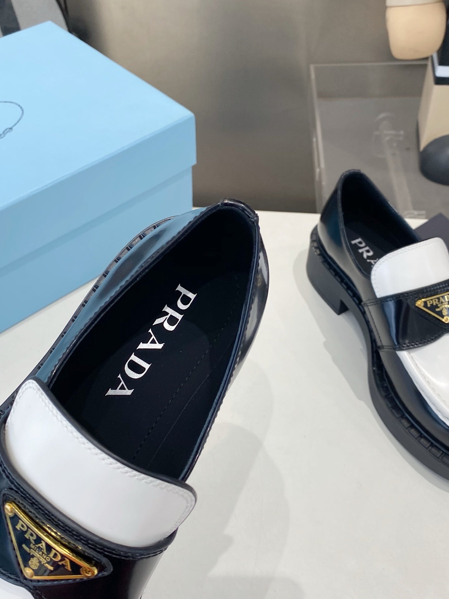 PRADA 26S LOAFERS IN BLACK AND WHITE CALFSKIN WITH LOGO