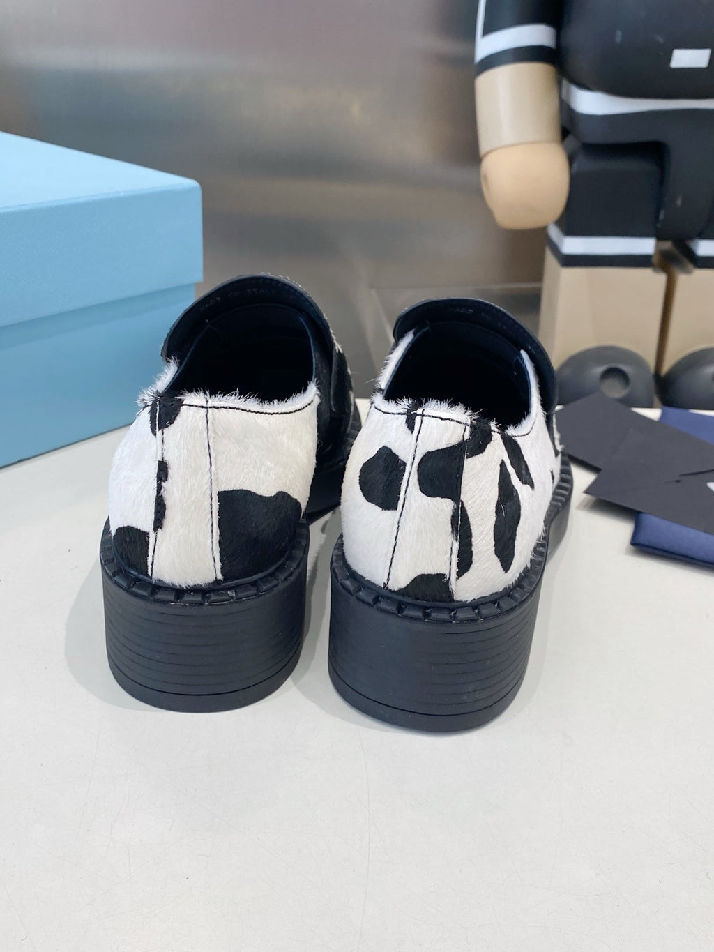 PRADA 26S LOAFERS IN WHITE AND BLACK COW PRINT PONY HAIR