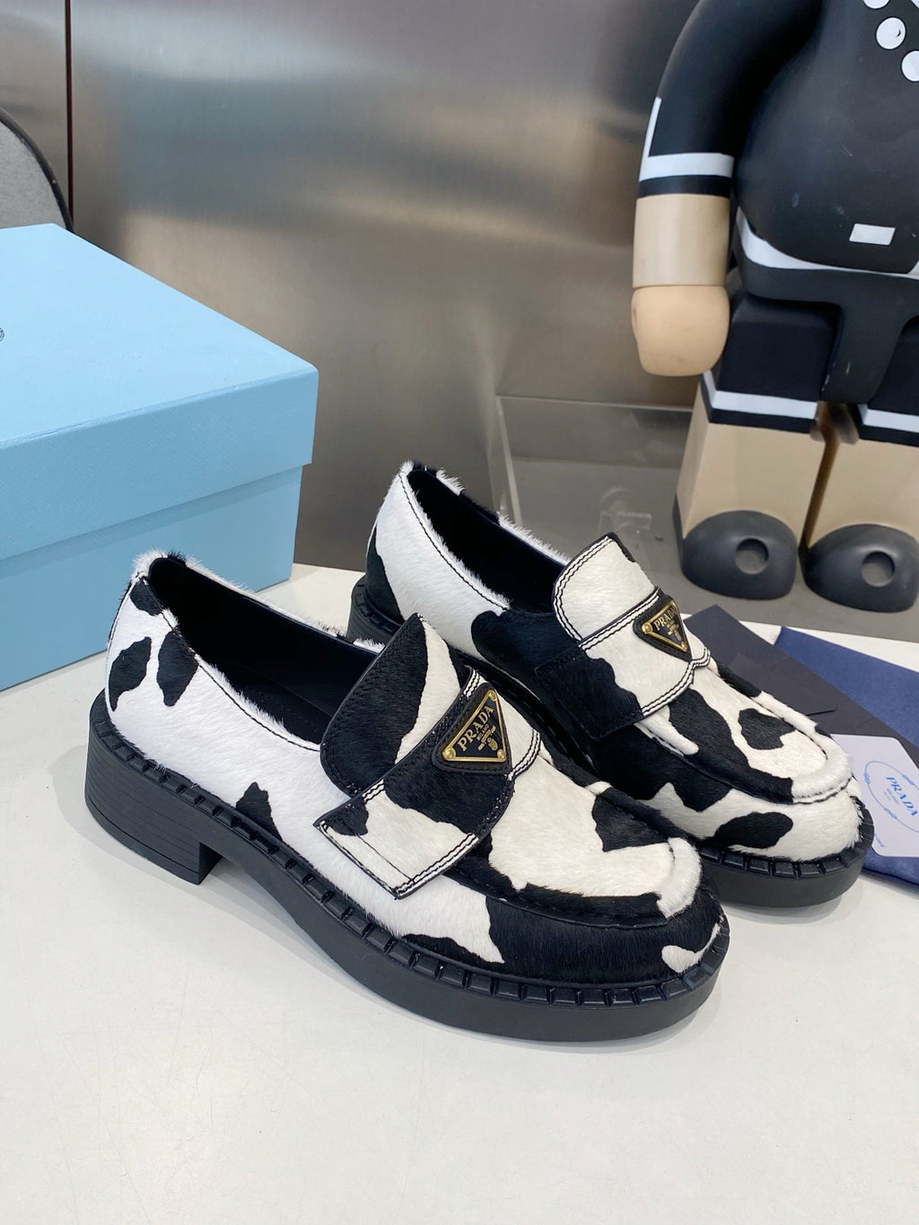 PRADA 26S LOAFERS IN WHITE AND BLACK COW PRINT PONY HAIR