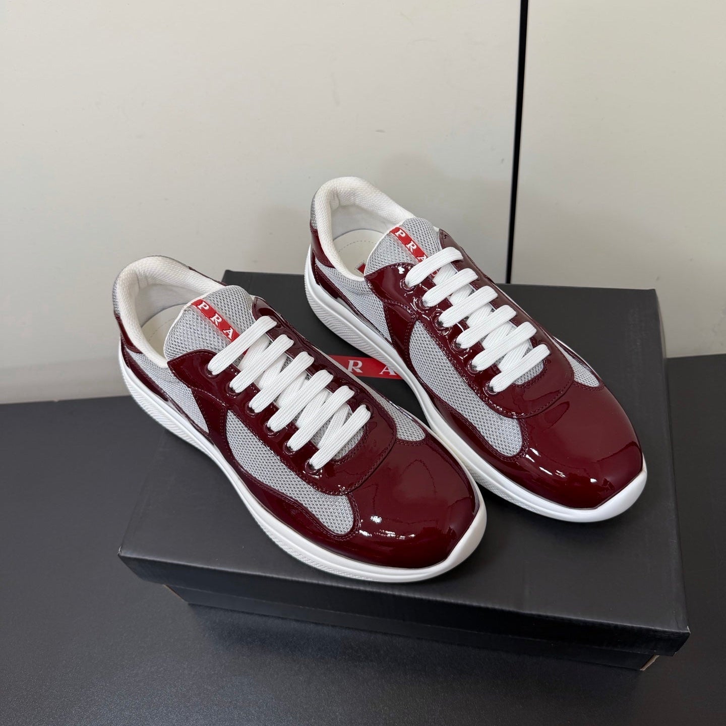 PRADA 26S SNEAKERS IN BURGUNDY RED PATENT CALFSKIN AND WHITE MESH