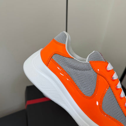 PRADA 26S SNEAKERS IN ORANGE PATENT CALFSKIN AND WHITE MESH