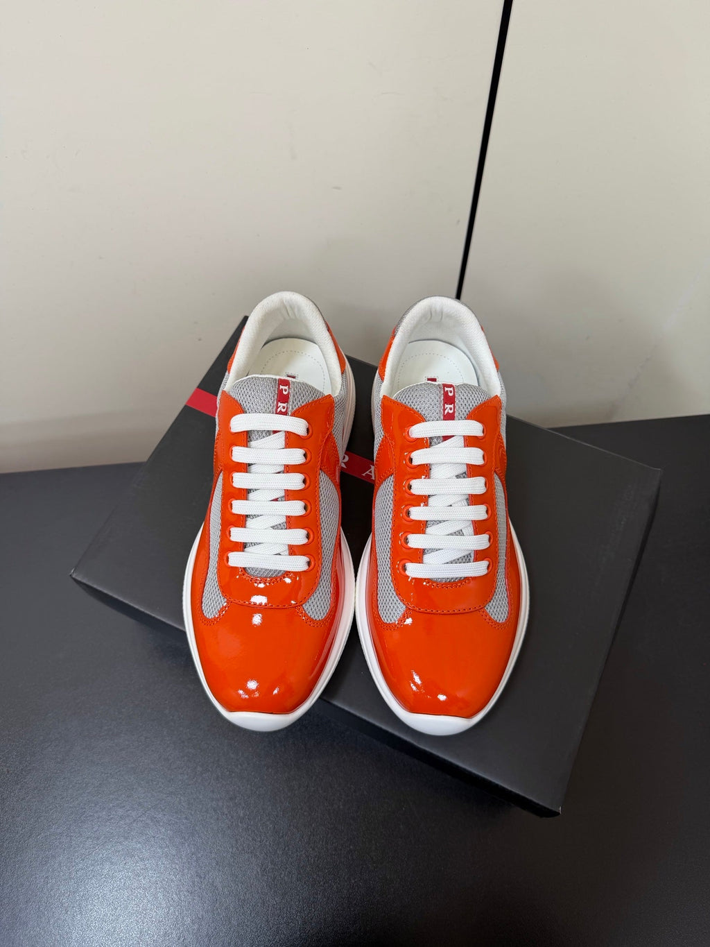 PRADA 26S SNEAKERS IN RED ORANGE PATENT CALFSKIN AND WHITE MESH