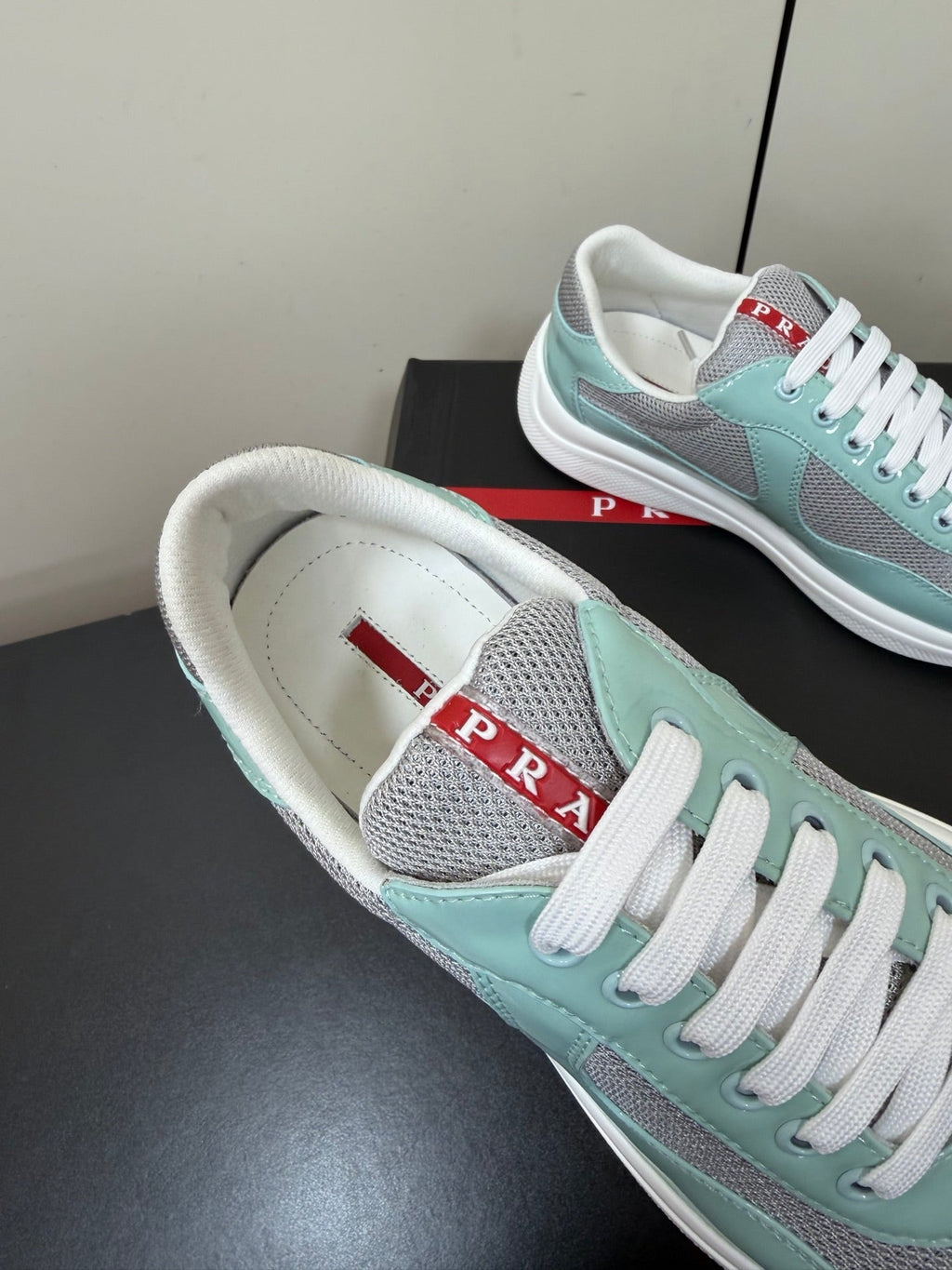 PRADA 26S SNEAKERS IN SOFT TEAL PATENT CALFSKIN AND WHITE MESH