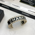 CHANEL 26S CHANEL LOGO BLACK ENAMEL STATEMENT CUFF BRACELET IN GOLD METAL 630834