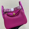 HM 25S MINI LINDY 19 CM IN DARK PINK COWHIDE WITH CROCODILE HANDLE AND GOLD HARDWARE