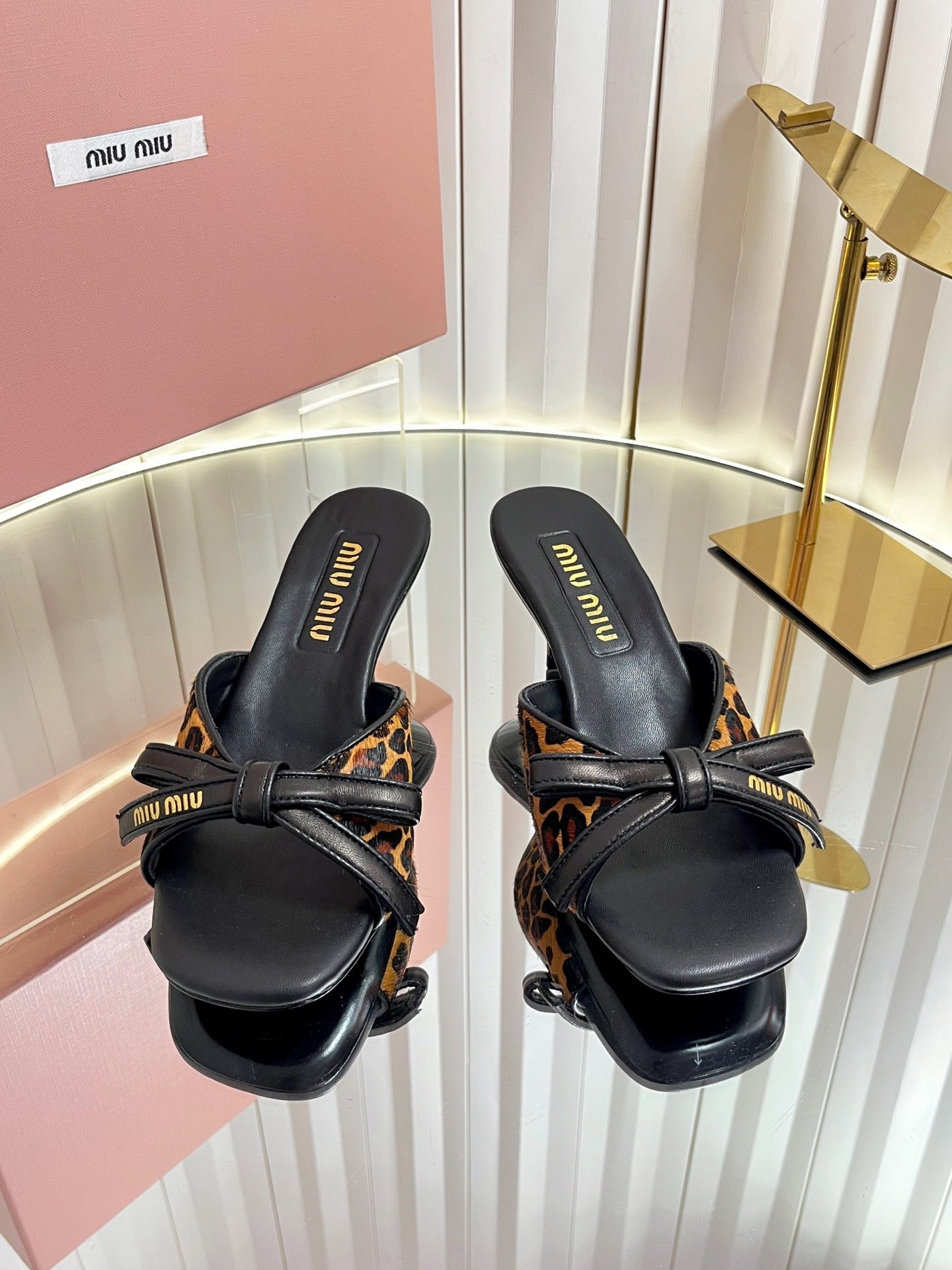 MIUMIU 26S MULE SANDALS 55MM IN LEOPARD PRINT CALF HAIR WITH BOW