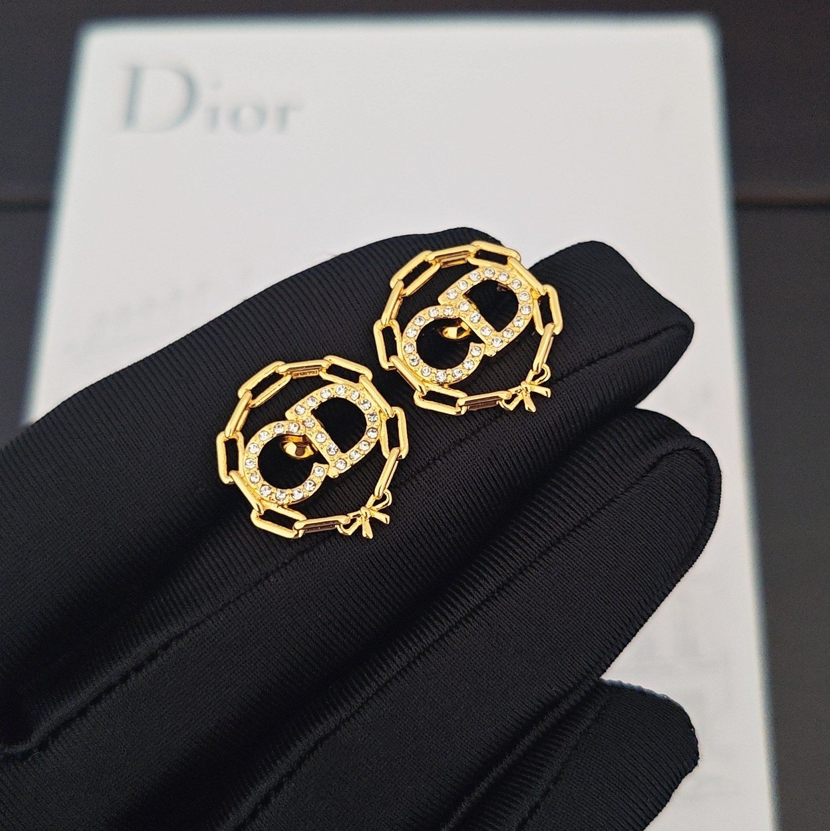 CD 26S CRYSTAL CHAIN LOGO STUD EARRINGS IN GOLD TONE METAL 645589