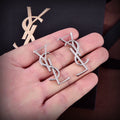 YSL 26S CLASSIC MONOGRAM DROP EARRINGS IN SILVER TONE METAL 629090