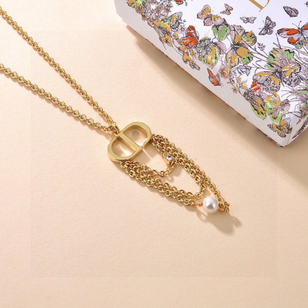 CD 26S PEARL CHAIN DROP LOGO NECKLACE IN GOLD TONE METAL WITH WHITE RESIN PEARL & CRYSTAL 631060