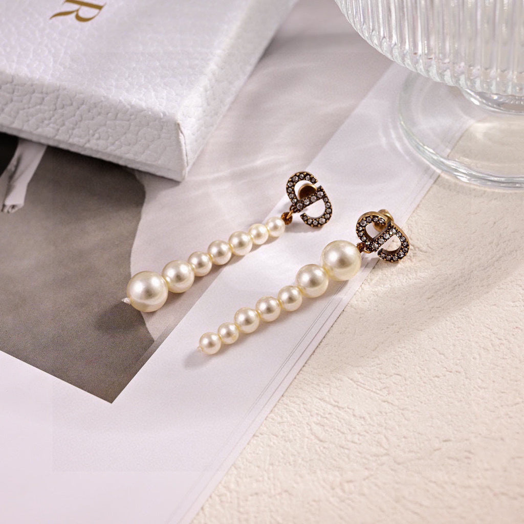 CD 26S PAVE LOGO PEARL DROP EARRINGS IN GOLD TONE METAL 631791