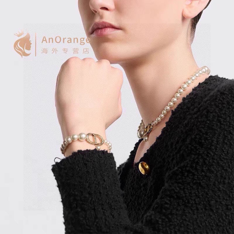 CD 26S PEARL STRAND CD CRYSTAL LOGO DROP NECKLACE IN GOLD TONE METAL 631858
