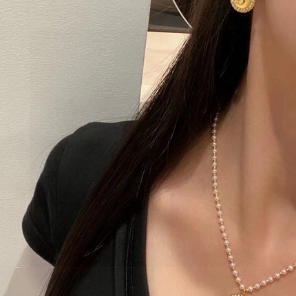 CD 26S DOUBLE PEARL MEDALLION LOGO DROP EARRINGS IN GOLD METAL