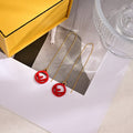 FENDI 26S FF LOGO THREADER EARRINGS IN RED RESIN AND GOLD TONE METAL 634941