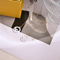 FENDI 26S FF LOGO THREADER EARRINGS IN WHITE RESIN AND GOLD TONE METAL 634941