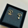 CD 26S MINI BOW PEARL DROP EARRINGS IN GOLD TONE METAL 646612
