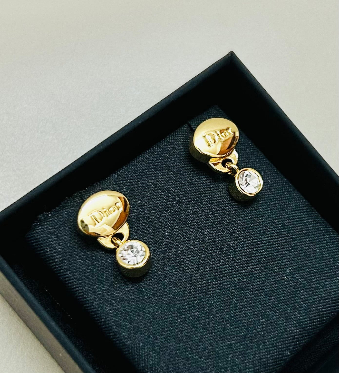 CD 26S CRYSTAL DROP LOGO STUD EARRINGS IN GOLD TONE METAL 646613
