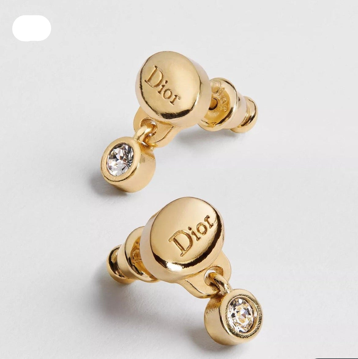 CD 26S CRYSTAL DROP LOGO STUD EARRINGS IN GOLD TONE METAL 646613