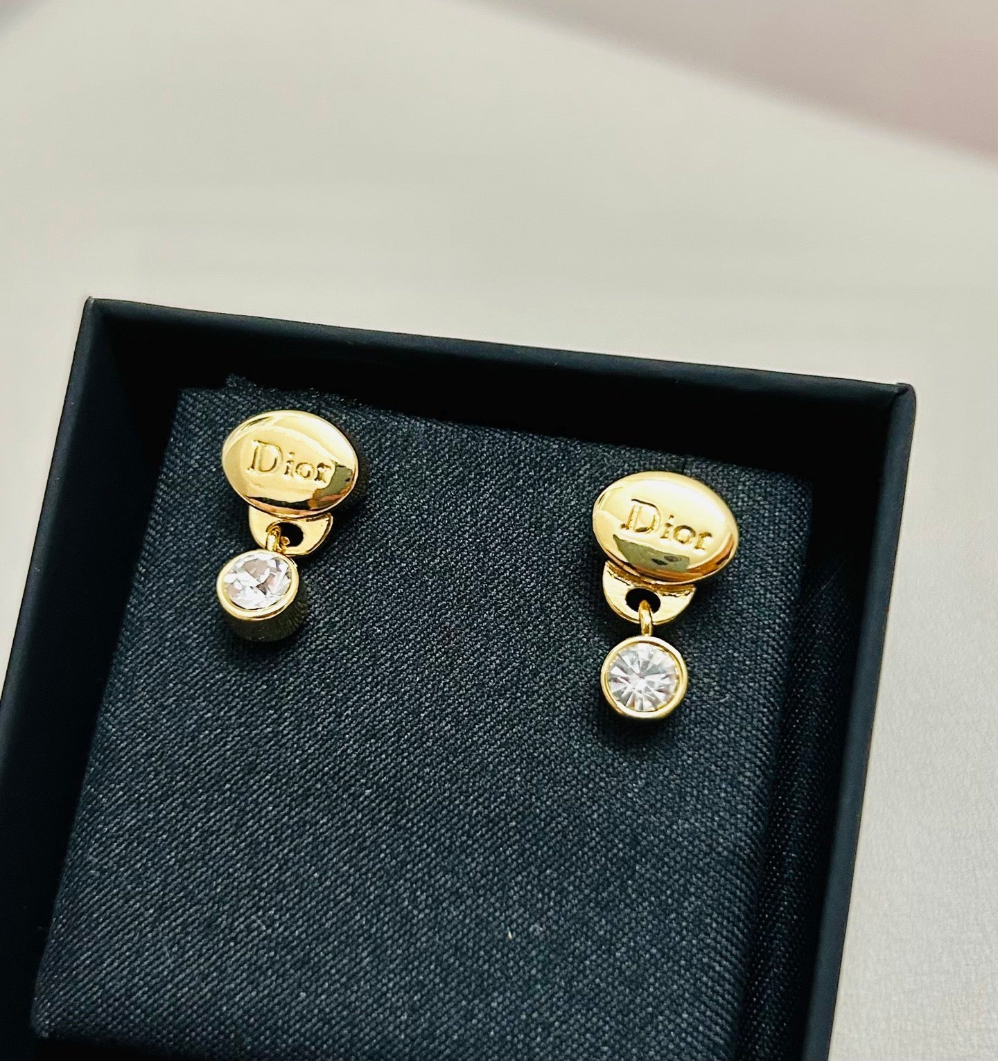 CD 26S CRYSTAL DROP LOGO STUD EARRINGS IN GOLD TONE METAL 646613