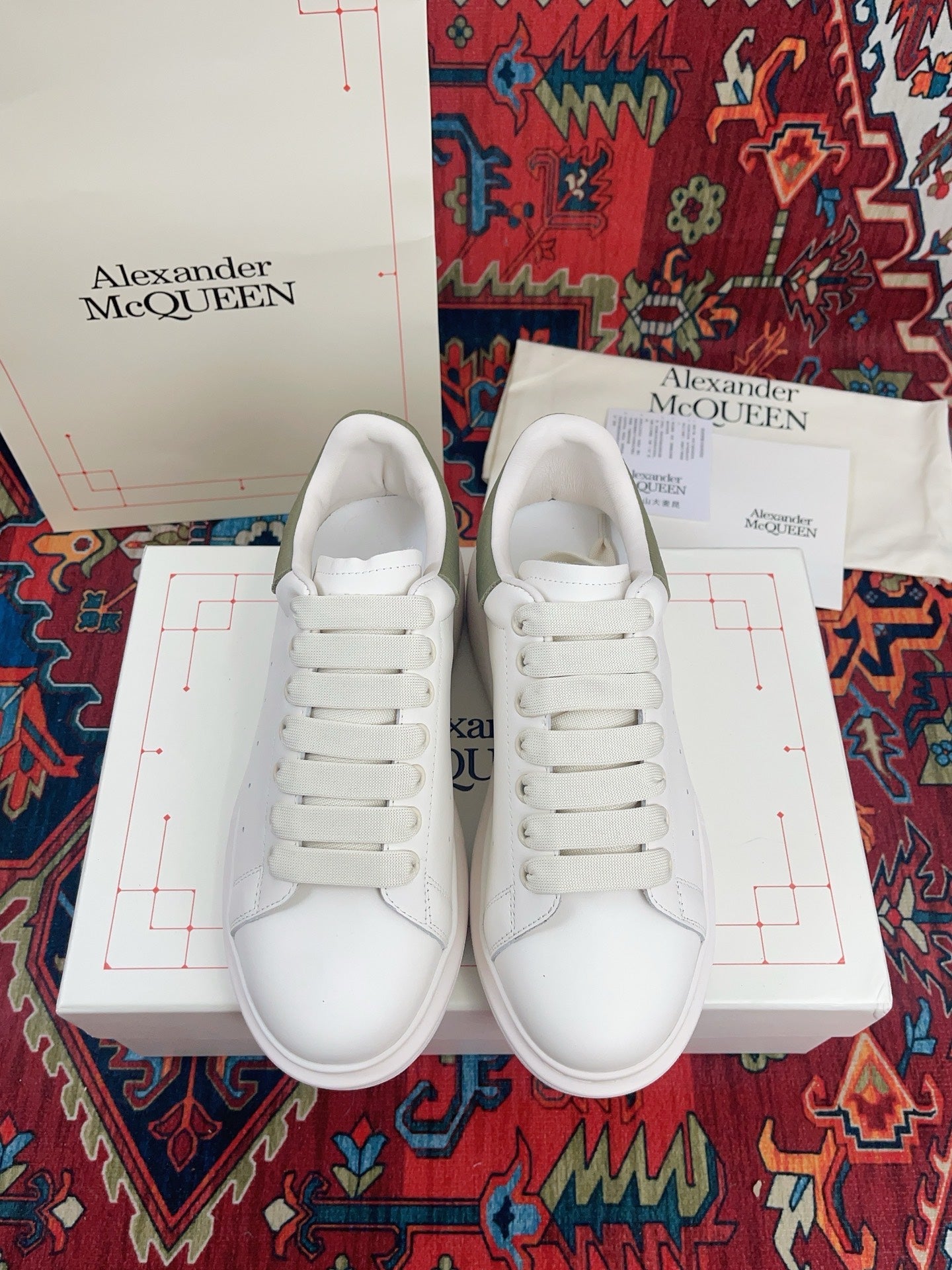 OVERSIZED SNEAKER IN WHITE CALFSKIN WITH EMBOSSED OLIVE GREEN HEEL TAB