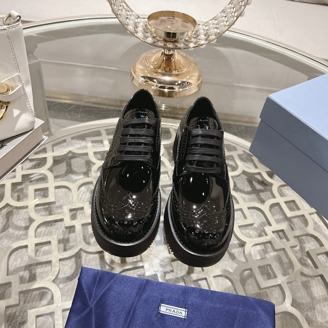 PRADA 26S BROGUE SHOES IN BLACK PATENT CALFSKIN