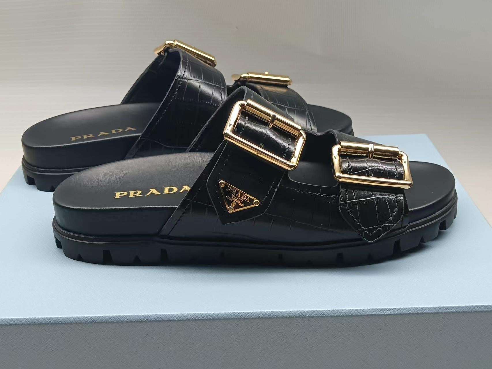 PRADA 26S STRAP SLIDES IN BLACK CROC EMBOSSED CALFSKIN GOLD HARDWARE