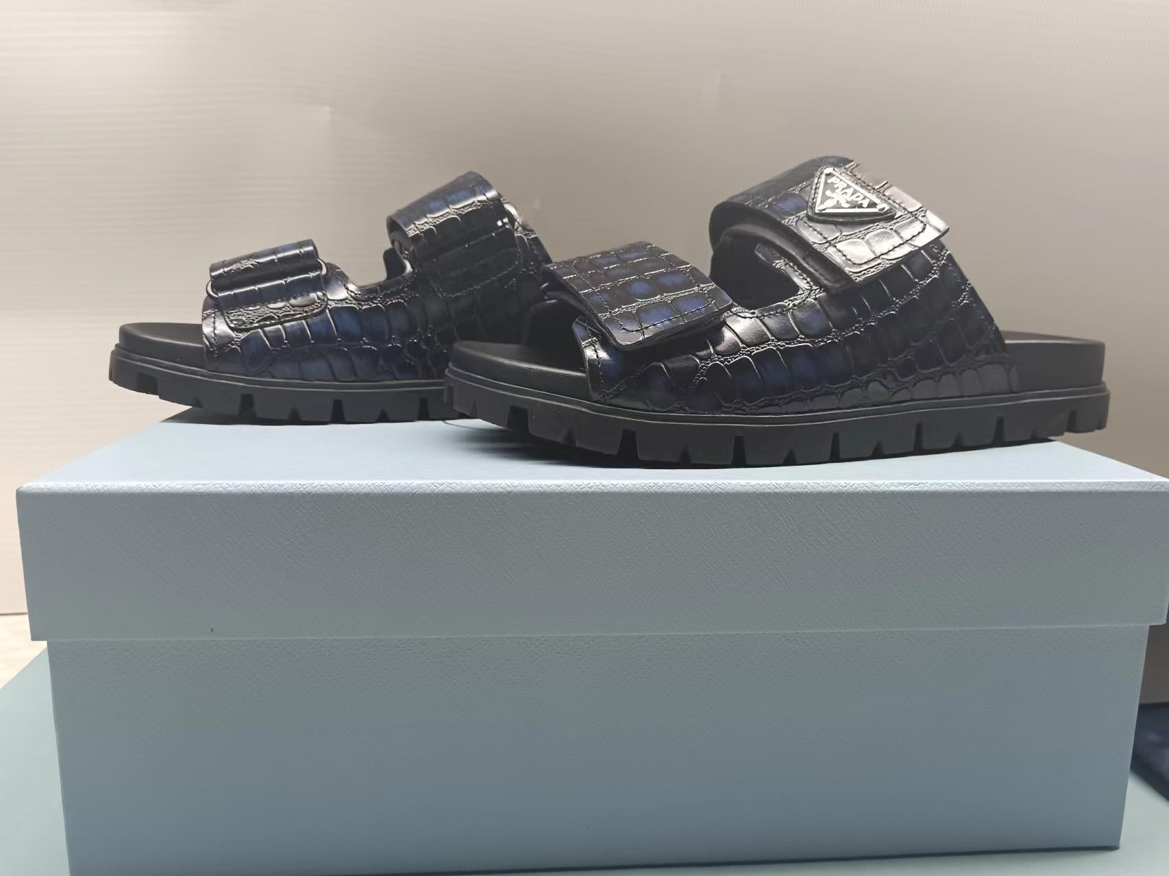 PRADA 26S STRAP SLIDES IN BLACK CROC EMBOSSED CALFSKIN