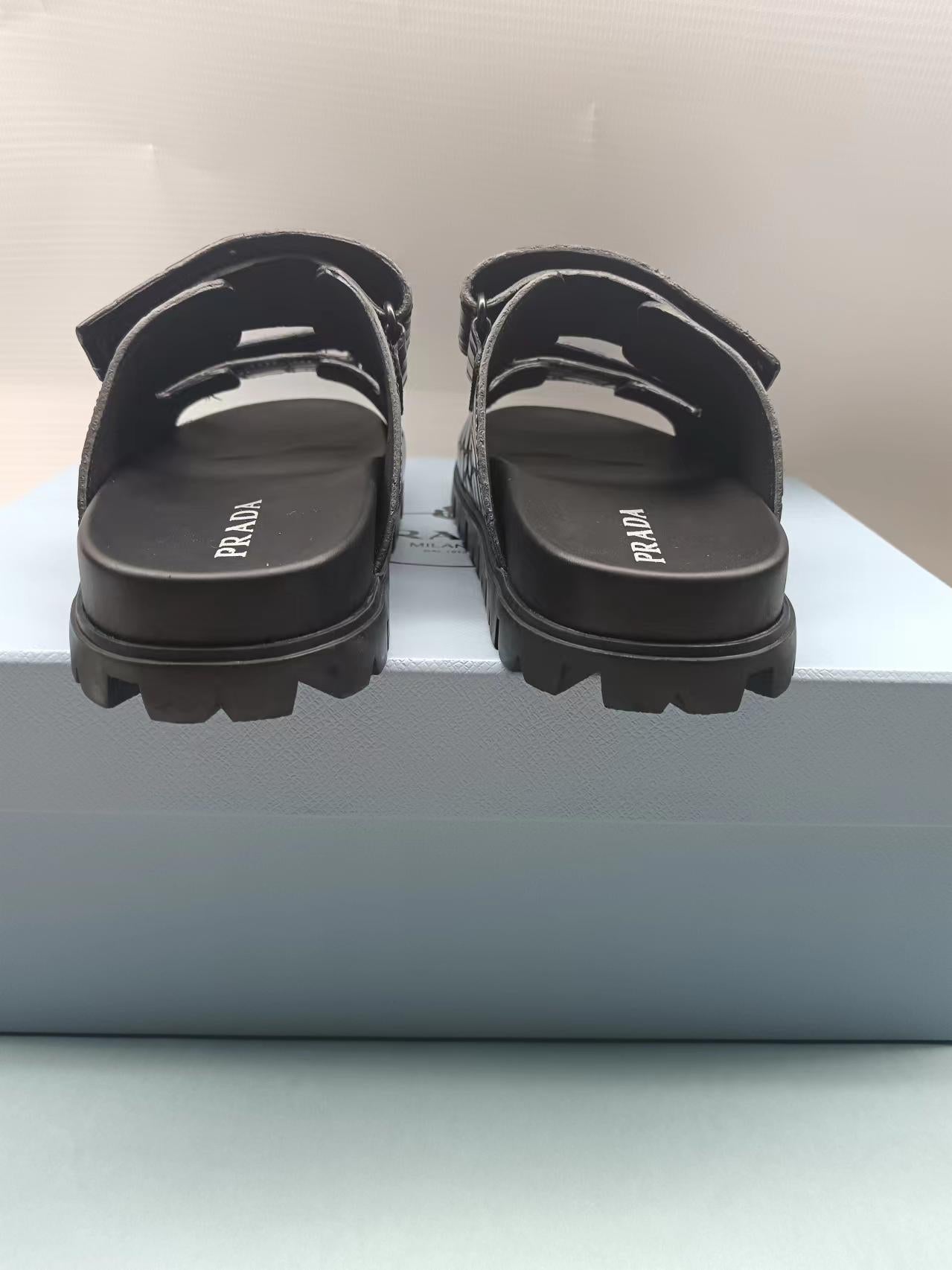 PRADA 26S STRAP SLIDES IN BLACK CROC EMBOSSED CALFSKIN