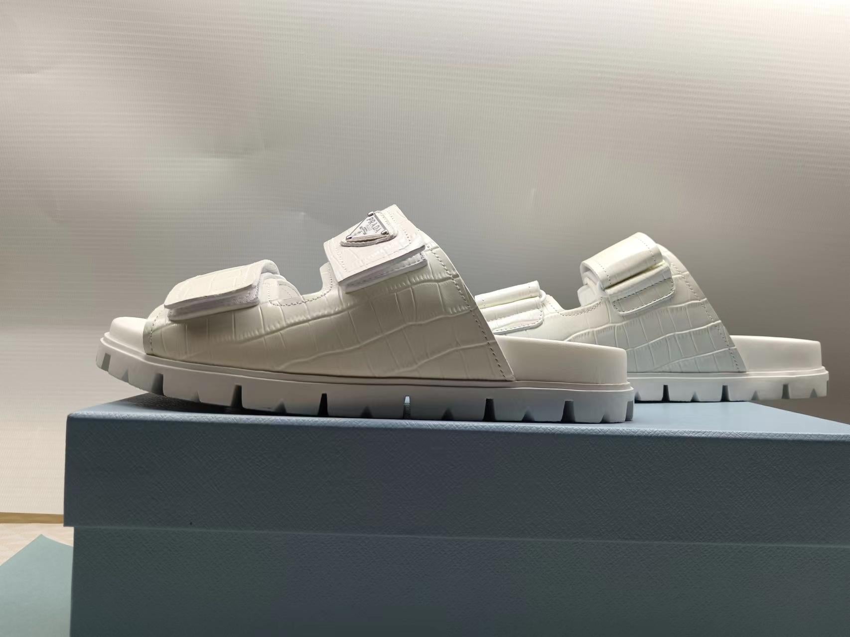 PRADA 26S STRAP SLIDES IN IVORY WHITE CROC EMBOSSED CALFSKIN