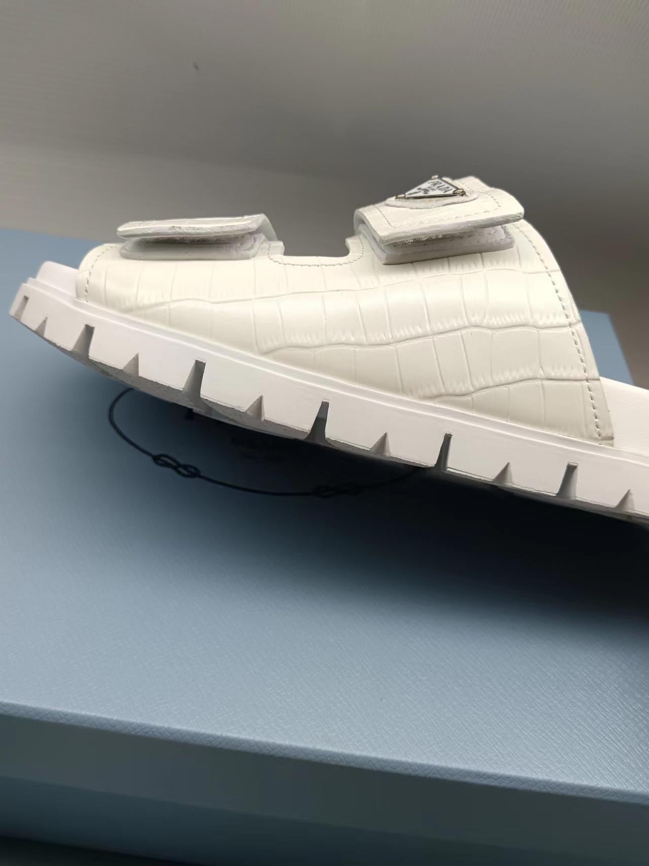 PRADA 26S STRAP SLIDES IN IVORY WHITE CROC EMBOSSED CALFSKIN