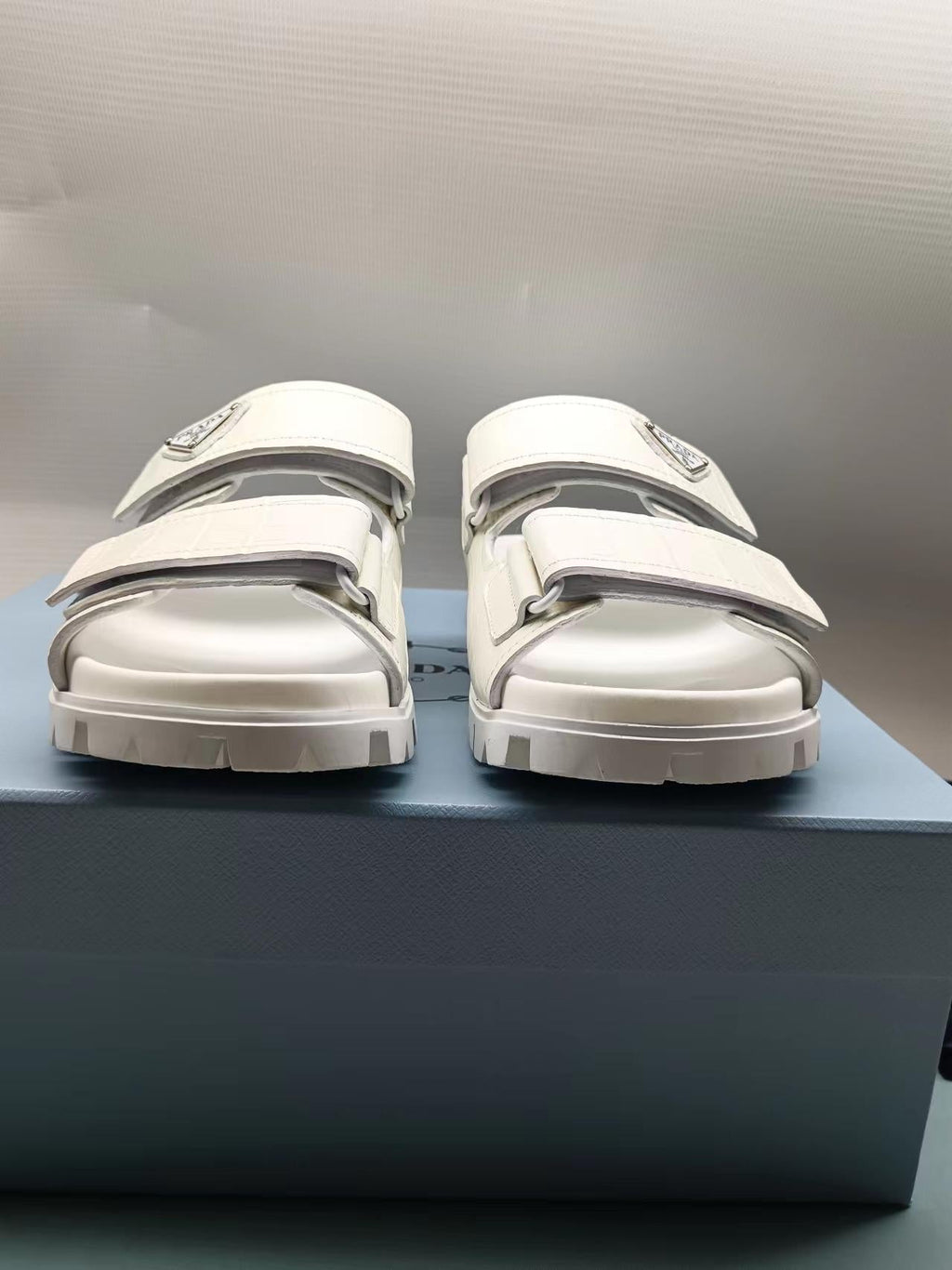PRADA 26S STRAP SLIDES IN IVORY WHITE CROC EMBOSSED CALFSKIN