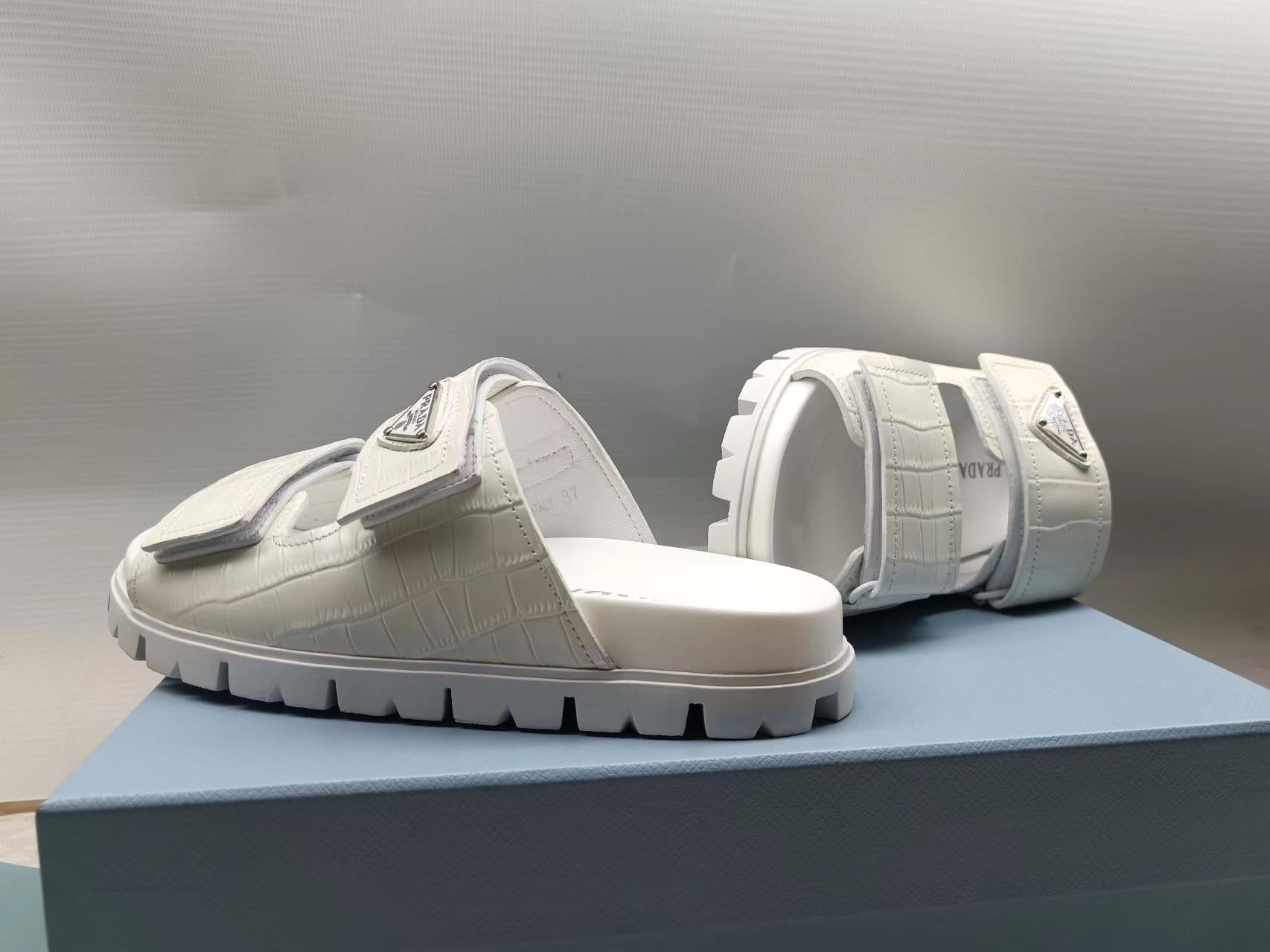 PRADA 26S STRAP SLIDES IN IVORY WHITE CROC EMBOSSED CALFSKIN