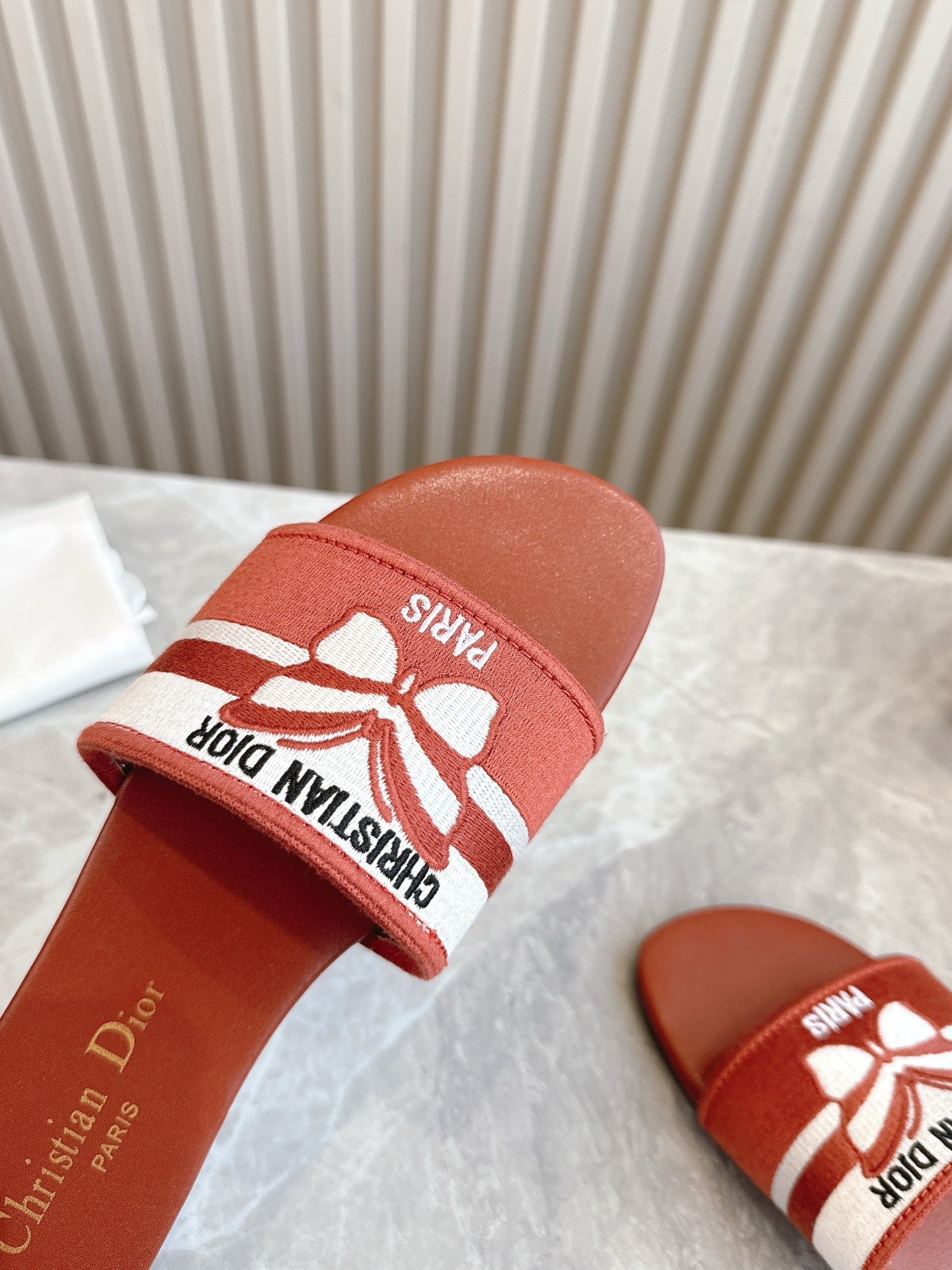 DIOR FLAT SLIDES 25S IN DARK ORANGE CALFSKIN AND FABRIC BRAND NAME EMBROIDERY