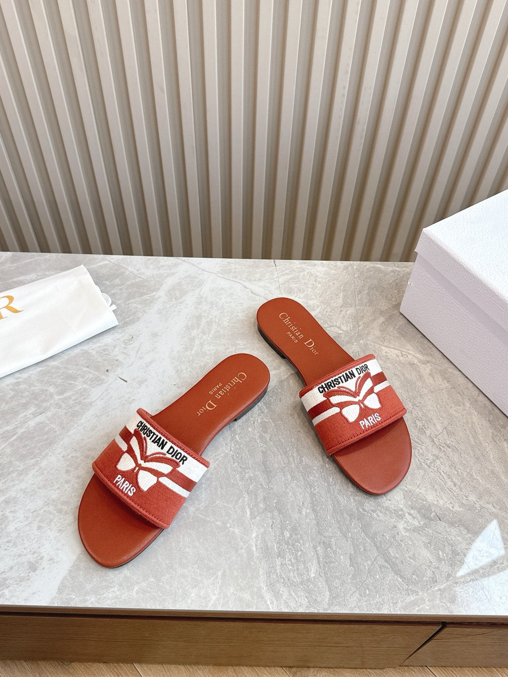 DIOR FLAT SLIDES 25S IN DARK ORANGE CALFSKIN AND FABRIC BRAND NAME EMBROIDERY