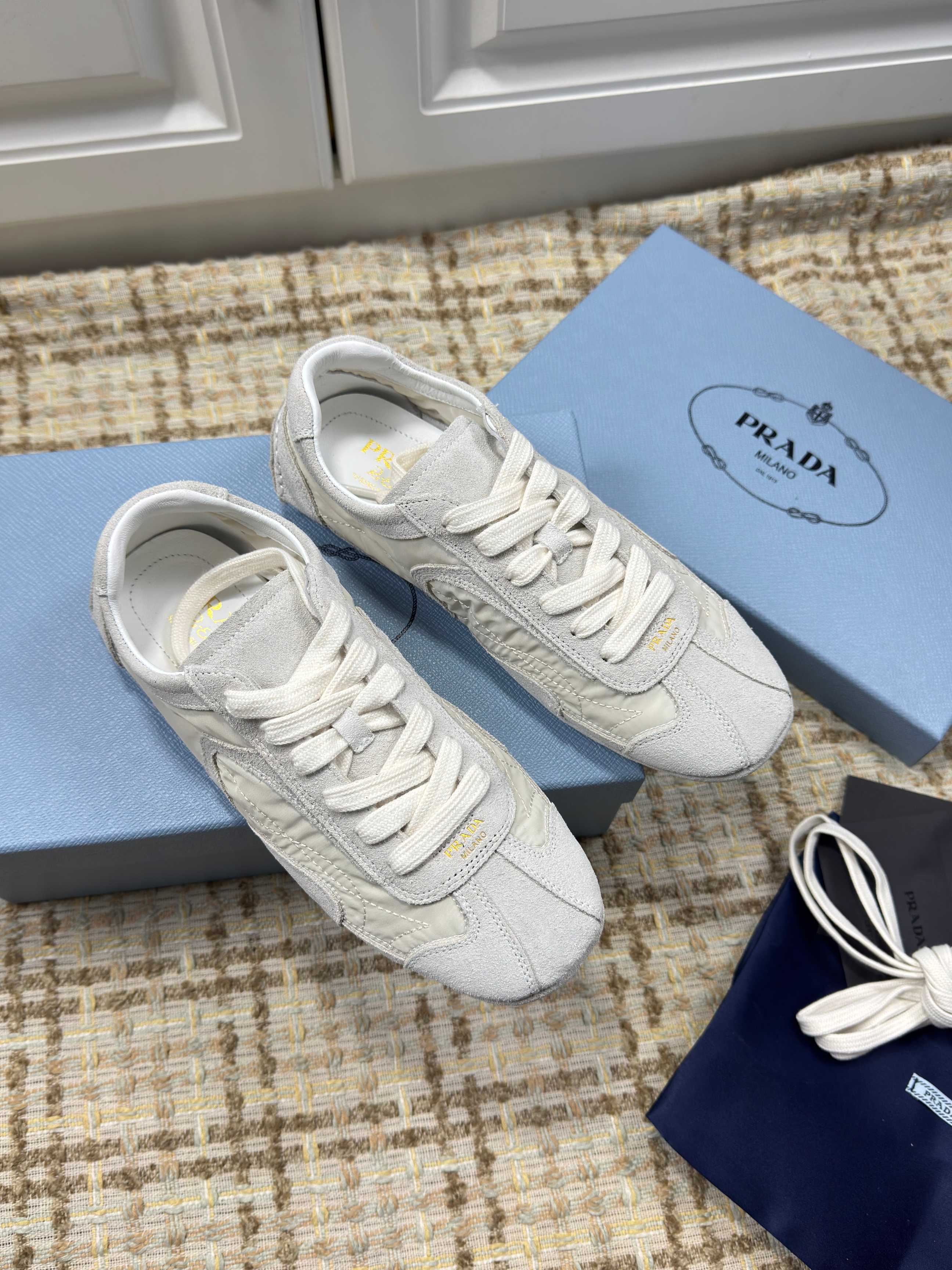 PRADA 26S LOW TOP SNEAKERS IN WHITE NYLON AND SUEDE