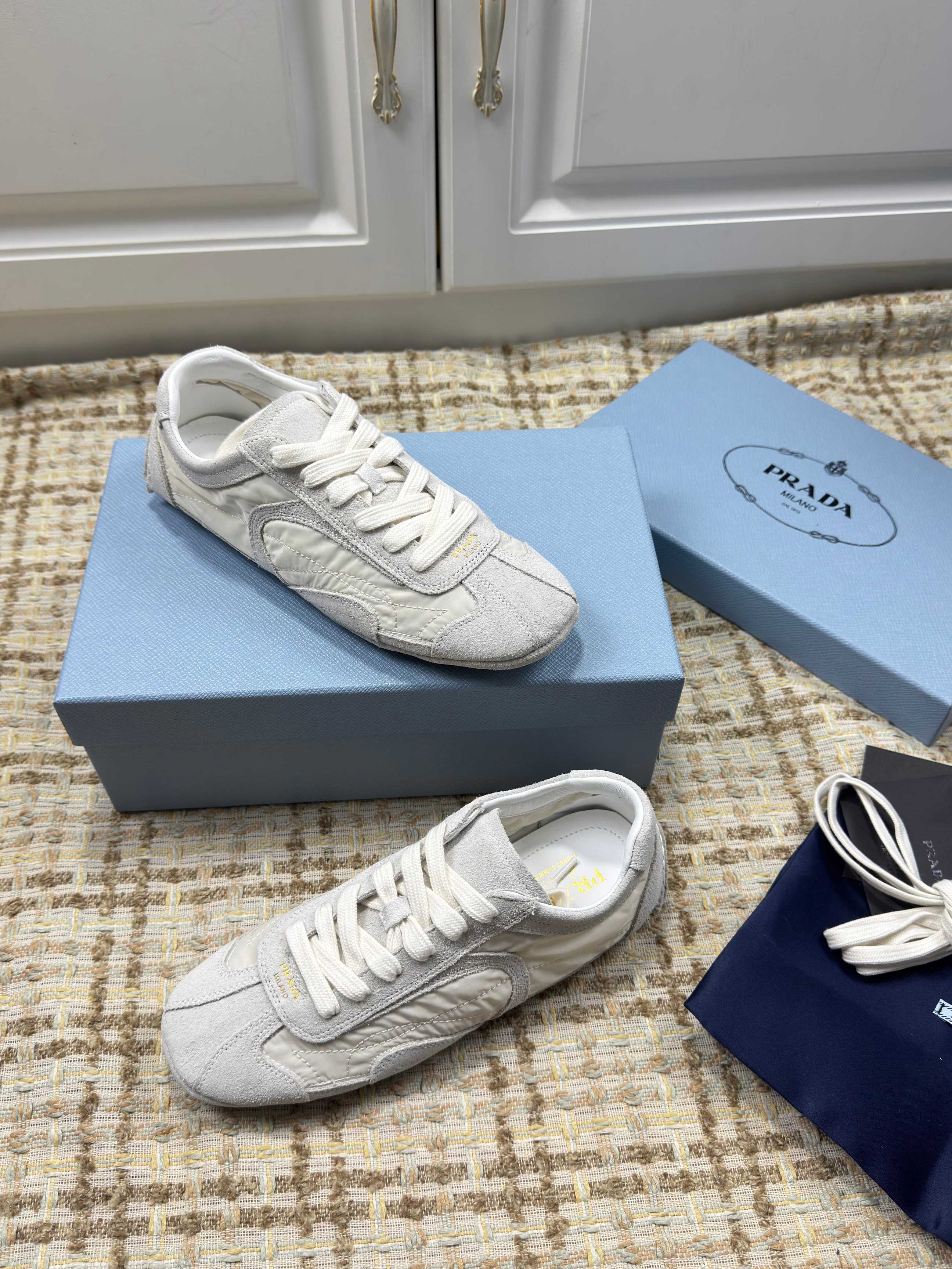 PRADA 26S LOW TOP SNEAKERS IN WHITE NYLON AND SUEDE