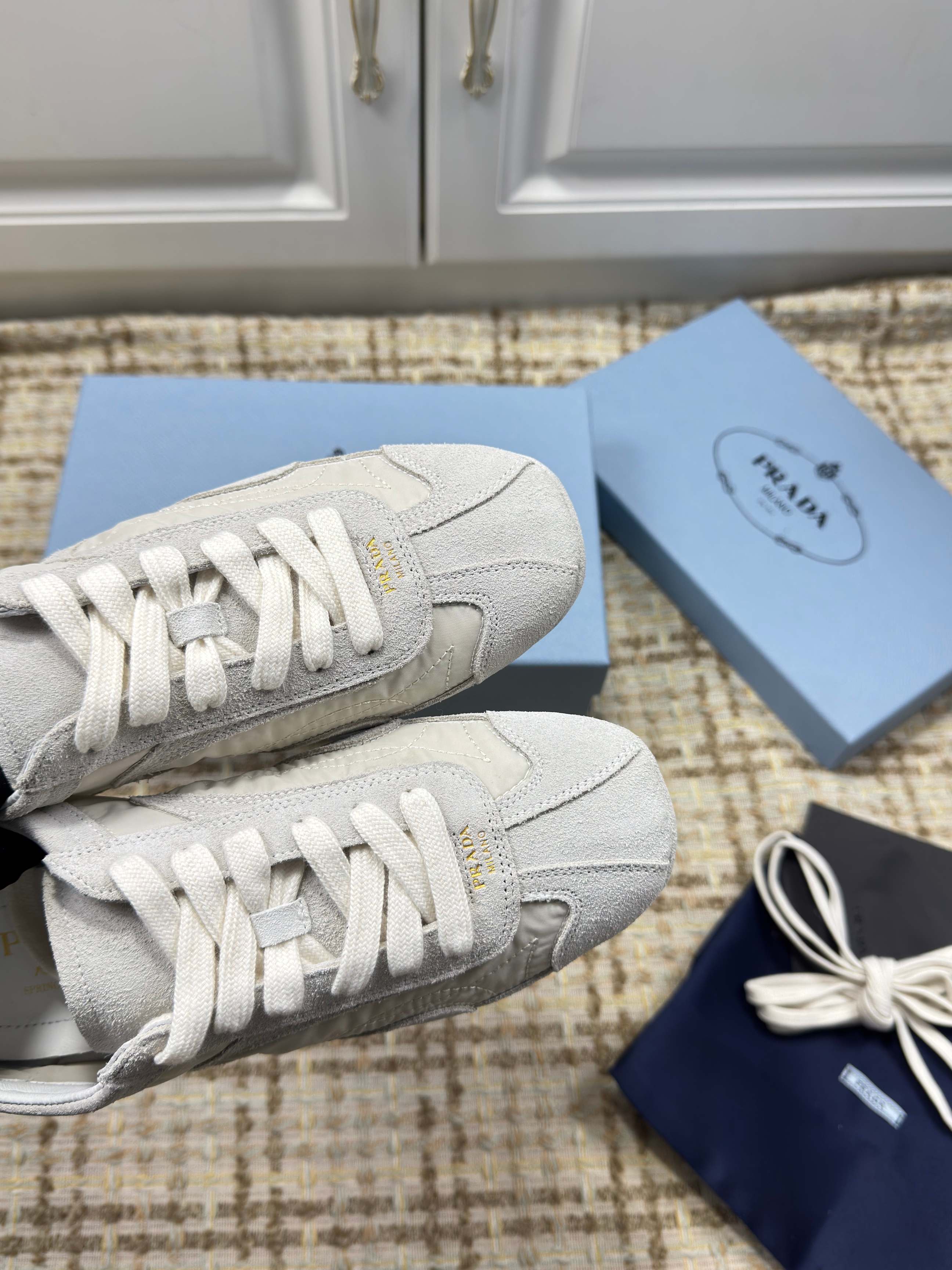 PRADA 26S LOW TOP SNEAKERS IN WHITE NYLON AND SUEDE