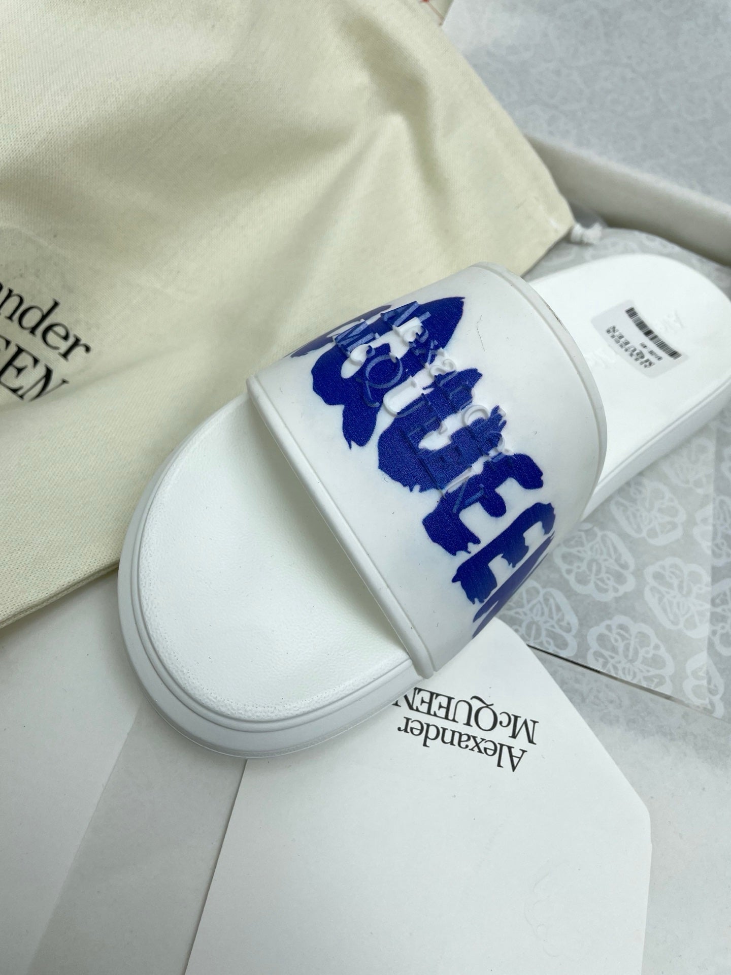 SLIDES SANDAL IN WHITE WITH BLUE LOGO GRAPHIC IN STRAP