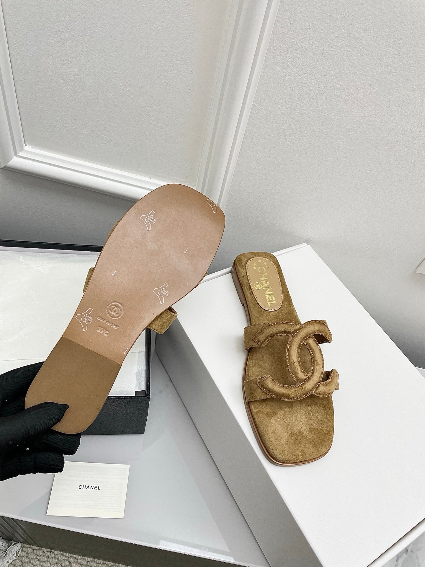 CHANEL CC LOGO MULES IN DARK BEIGE SUEDE