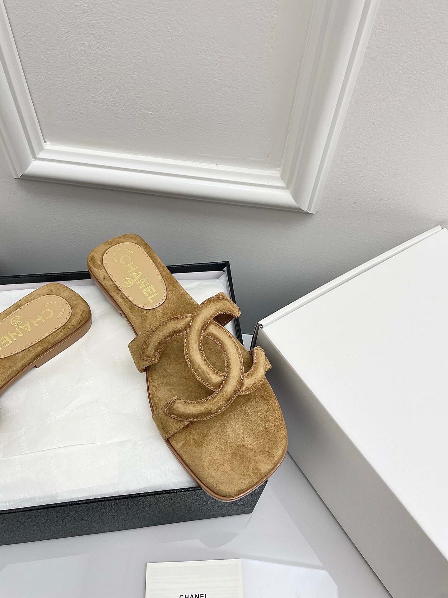 CHANEL CC LOGO MULES IN DARK BEIGE SUEDE