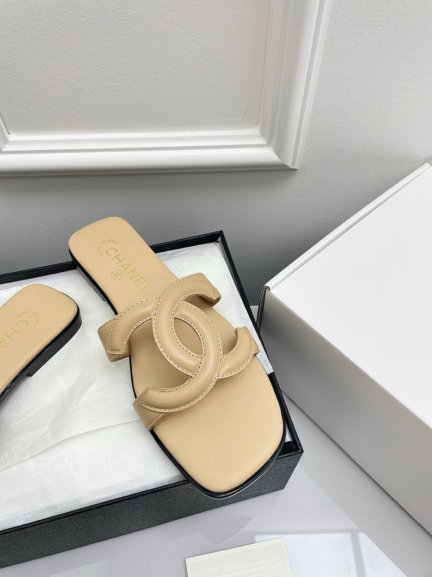 CHANEL CC LOGO MULES IN BEIGE CALFSKIN